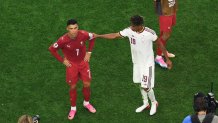 Lamine Yamal #19 of Spain interacts with Cristiano Ronaldo #7 of Portugal.